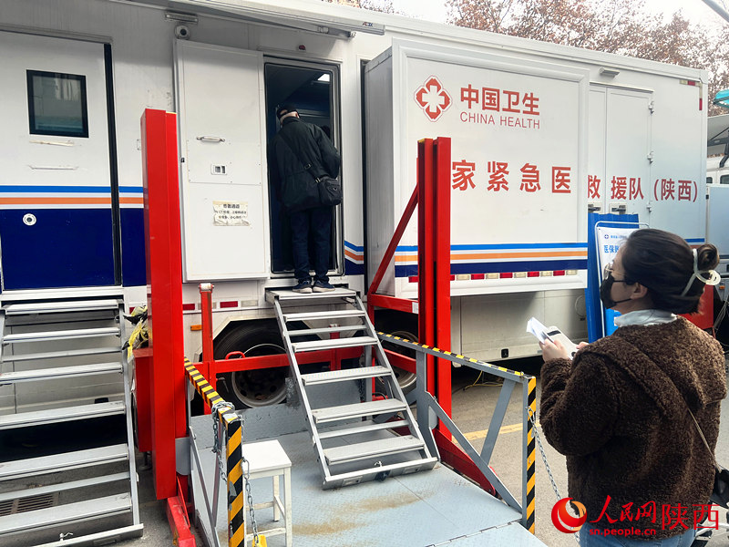 國家緊急醫(yī)學(xué)救援應(yīng)急CT車外，患者有序排隊(duì)做檢查。人民網(wǎng) 鄧楠攝
