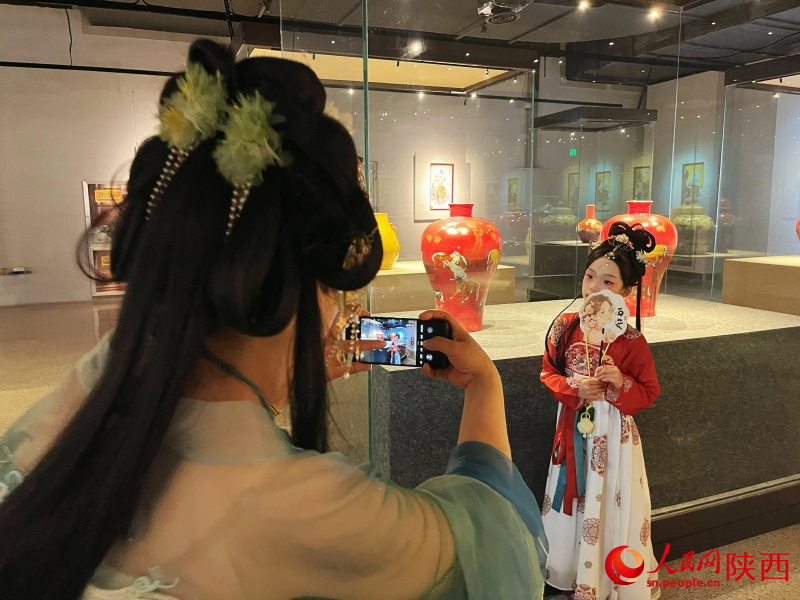 在陶瓷（藝）館，身著漢服的女子在給孩子拍照留念。 人民網記者 魏鑫攝